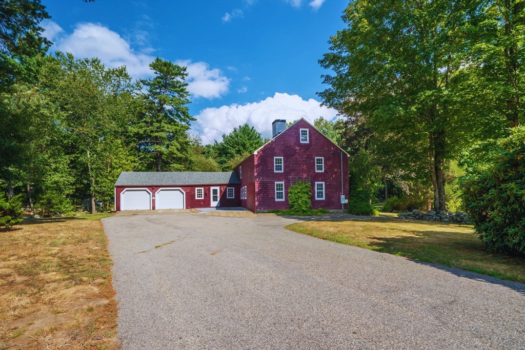 132 Maple Avenue Atkinson, NH 03811 - Photo 2 of 41 a front view of a house with a yard and garage