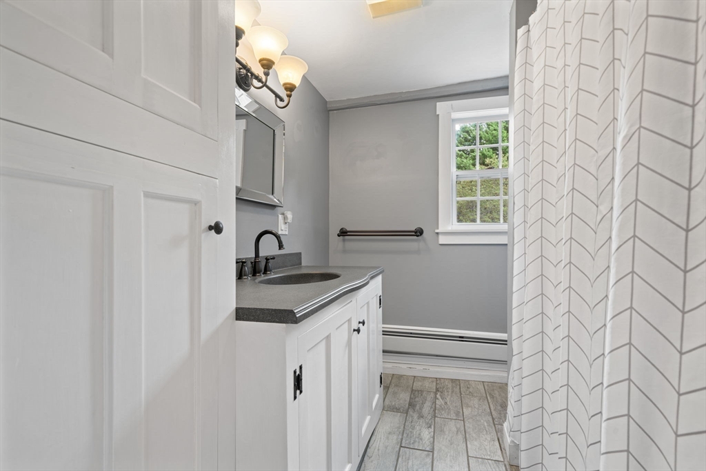 132 Maple Avenue Atkinson, NH 03811 - Photo 28 of 41 a bathroom with a sink a vanity and a mirror