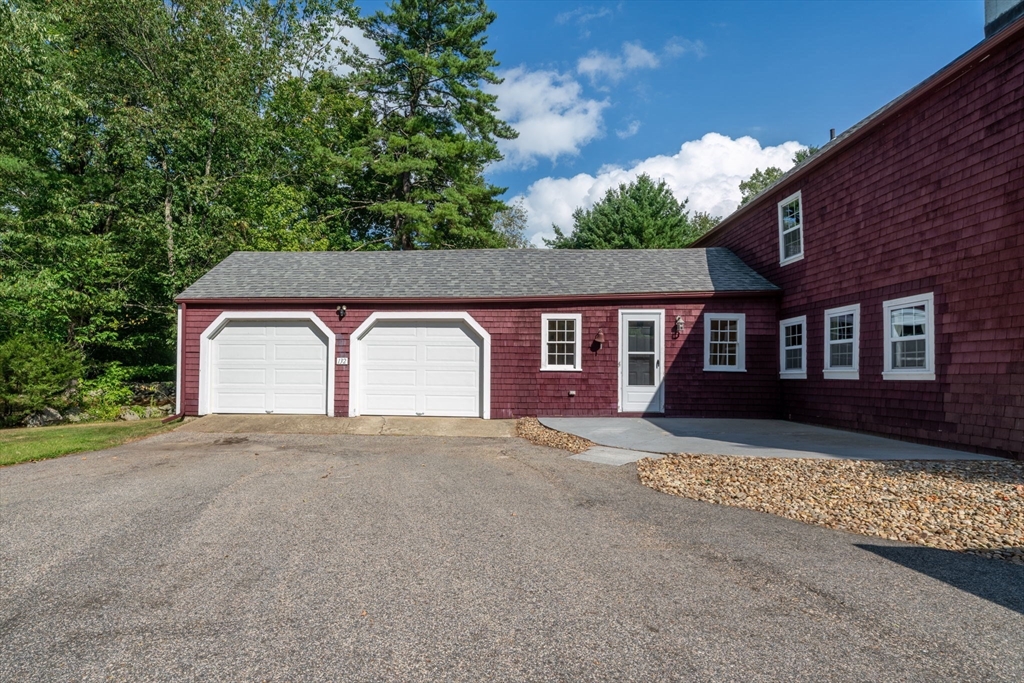 132 Maple Avenue Atkinson, NH 03811 - Photo 3 of 41 a front view of a house with a yard and garage