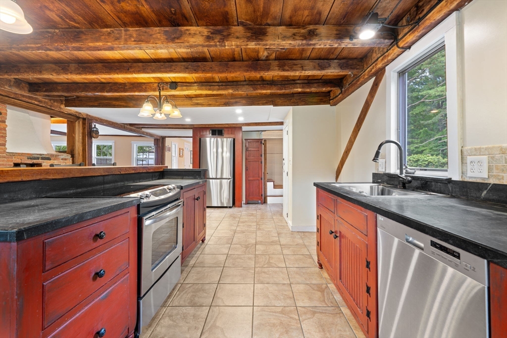 132 Maple Avenue Atkinson, NH 03811 - Photo 9 of 41 a large kitchen with stainless steel appliances granite countertop a sink and cabinets