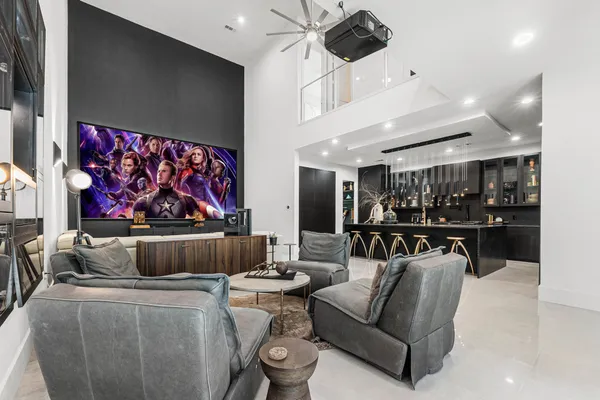 a living room with furniture and a painting on the wall