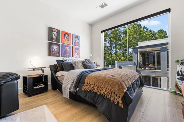 a bedroom with furniture and wooden floor