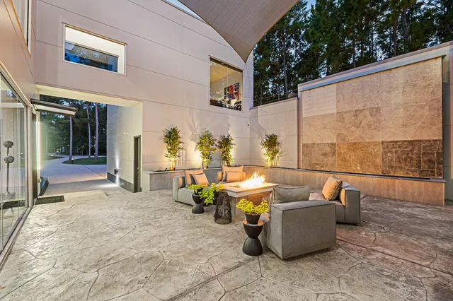 a dining room filled with furniture and a potted plant