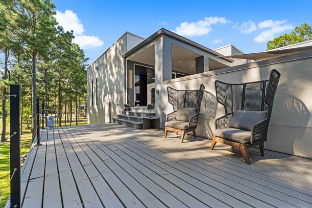 a view of a house with backyard and sitting area