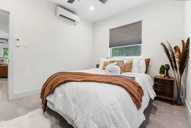 a living room with furniture and a floor to ceiling window
