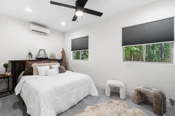 a living room with furniture a dining table and chairs with wooden floor