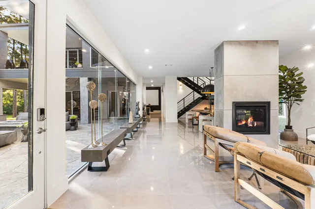 a living room with furniture lamp and a fireplace
