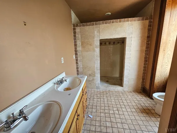 a bathroom with a tub sink and mirror
