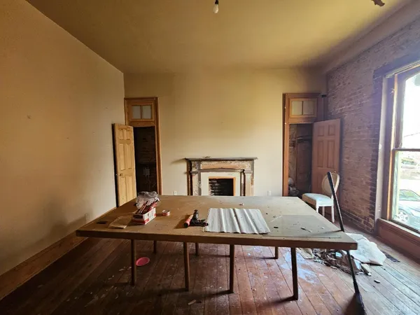 a living room with a table and chairs