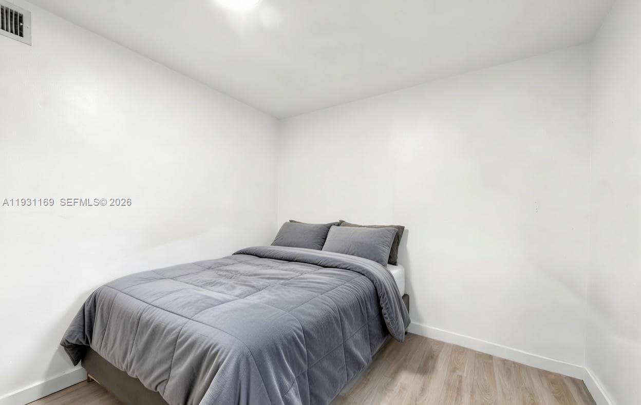 3700 North 56th Avenue, Unit 1012 Hollywood, FL 33021 - Photo 12 of 15 a bedroom with a bed and a window