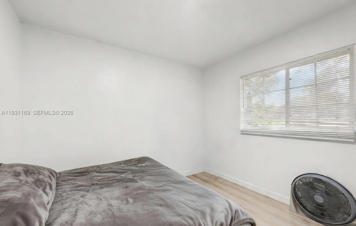 3700 North 56th Avenue, Unit 1012 Hollywood, FL 33021 - Photo 13 of 15 a bedroom with a bed and a window