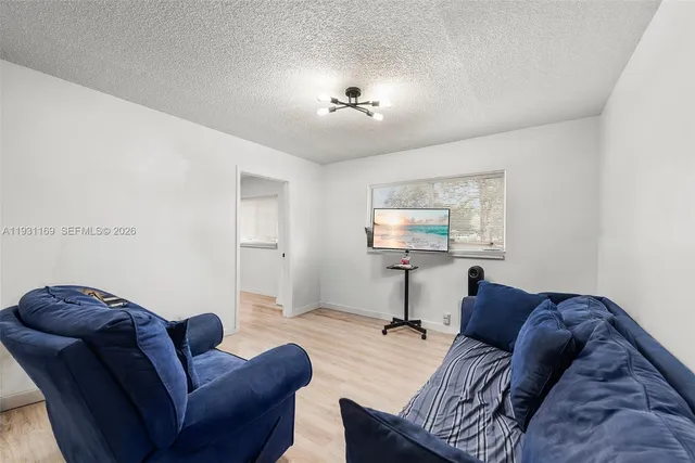 a living room with furniture a air conditioner vent and a window