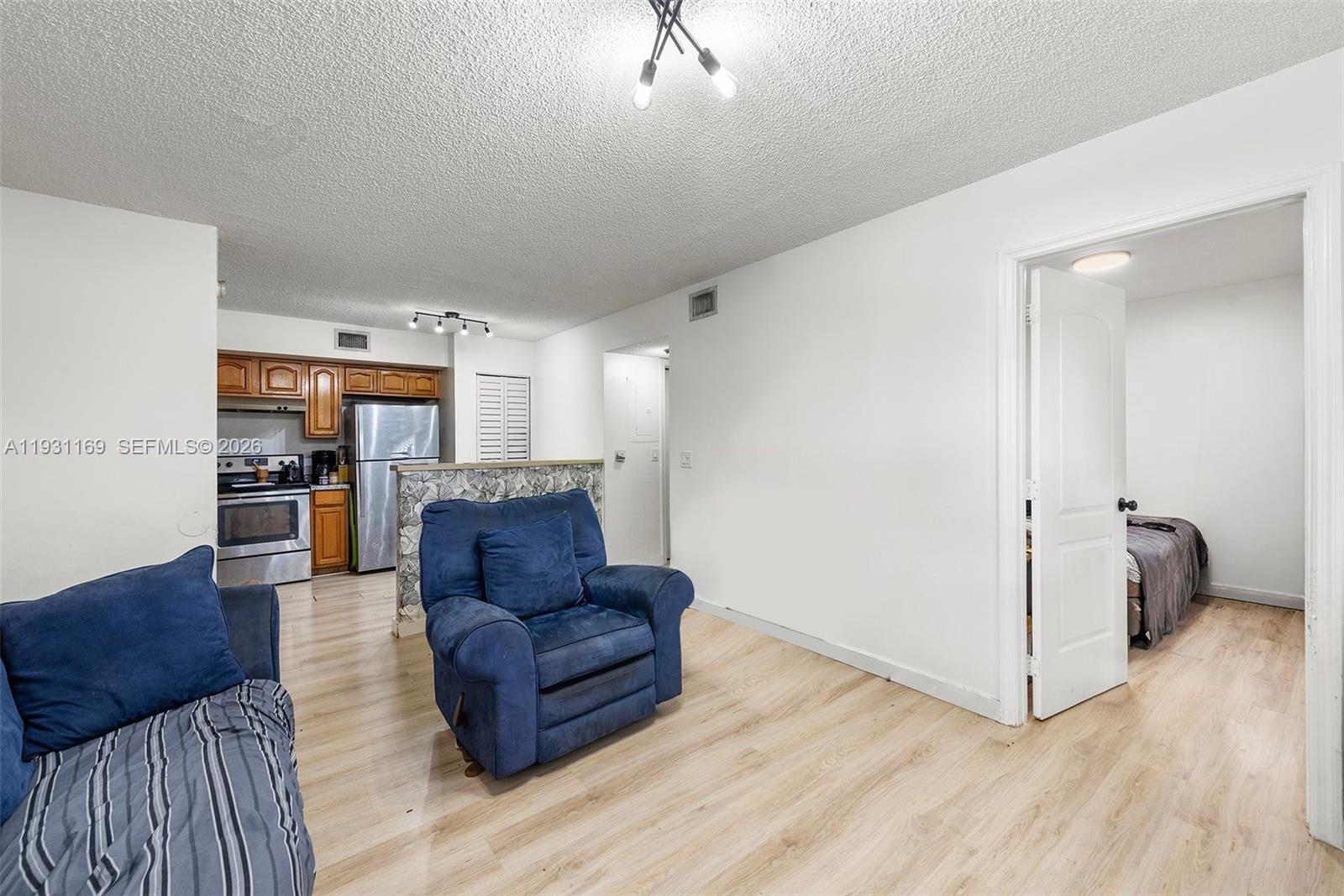 3700 North 56th Avenue, Unit 1012 Hollywood, FL 33021 - Photo 3 of 15 a living room with furniture and a wooden floor