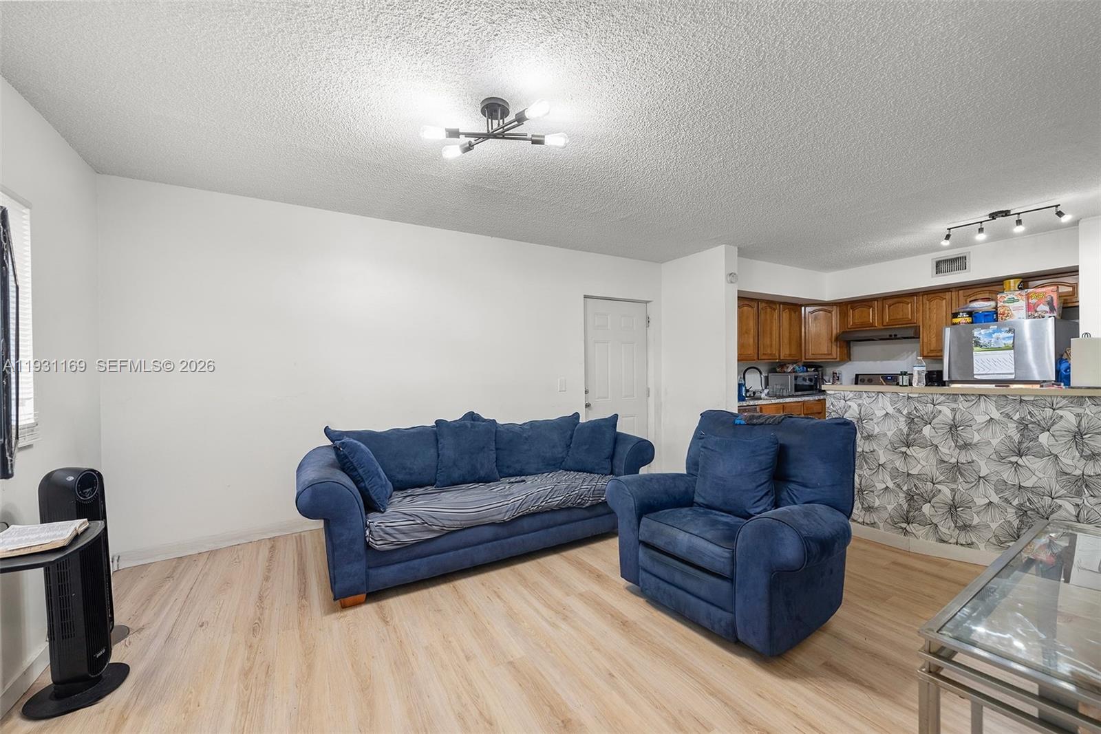 3700 North 56th Avenue, Unit 1012 Hollywood, FL 33021 - Photo 4 of 15 a living room with furniture and a wooden floor