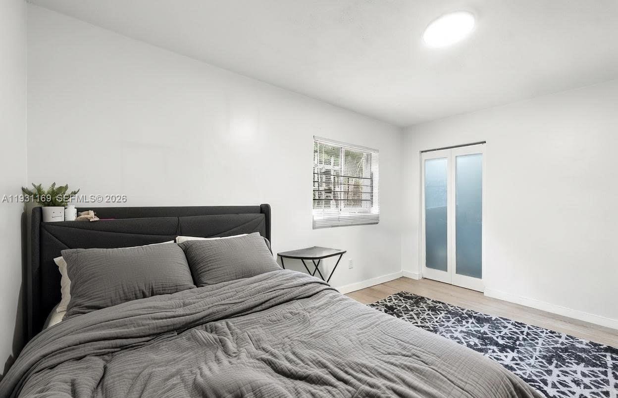 3700 North 56th Avenue, Unit 1012 Hollywood, FL 33021 - Photo 5 of 15 a bedroom with a bed and a window