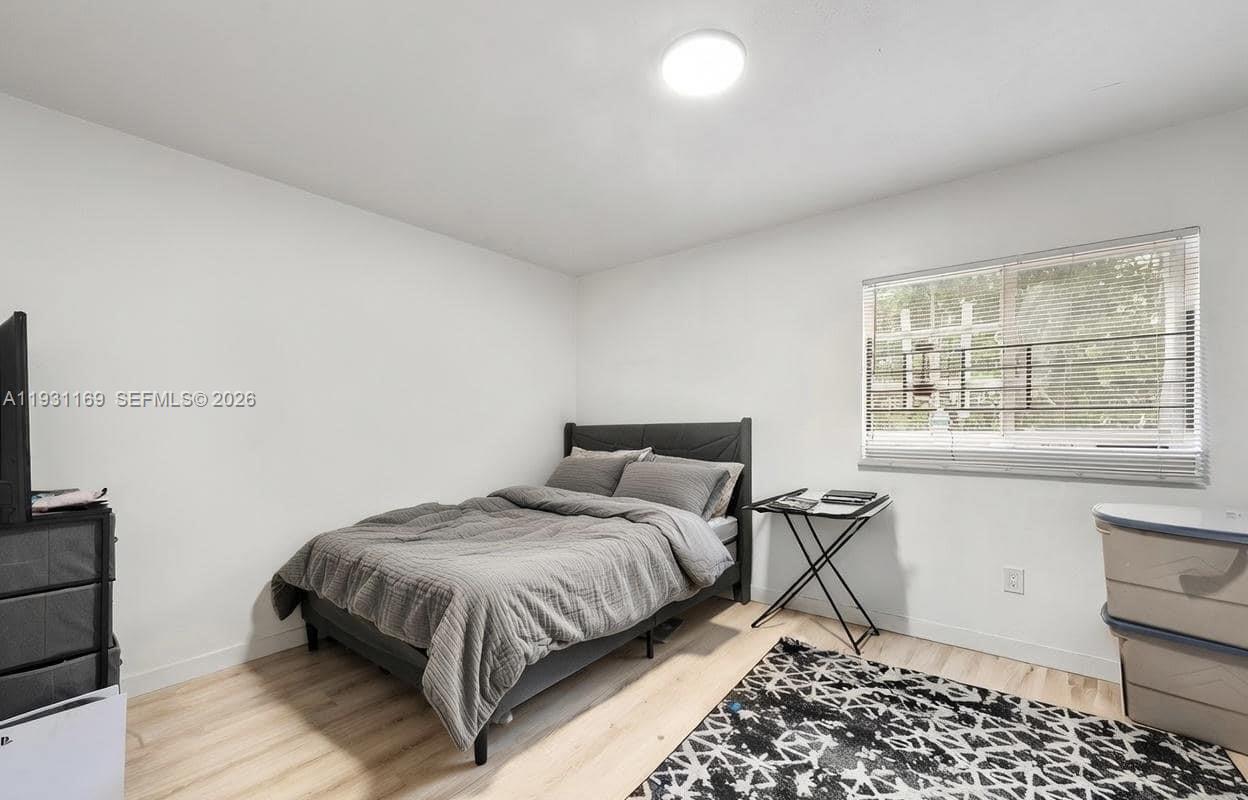 3700 North 56th Avenue, Unit 1012 Hollywood, FL 33021 - Photo 8 of 15 a bedroom with a bed and next to a window