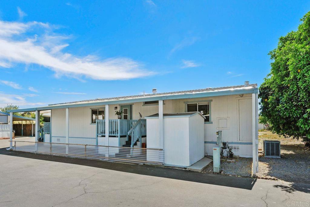 530 West Devonshire Avenue, Unit 84 Hemet, CA 92543 - Photo 33 of 36 a front view of a house with a garage