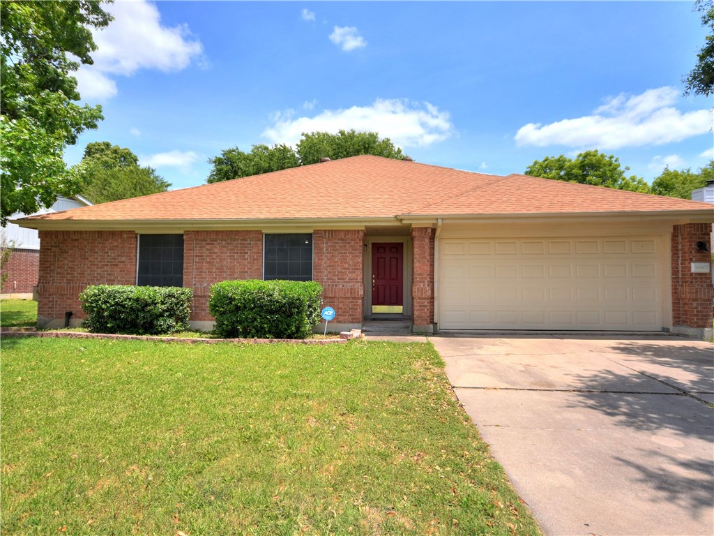 16807 Gravesend Road Pflugerville, TX 78660 - Photo 1 of 1 a front view of a house with a yard and garage
