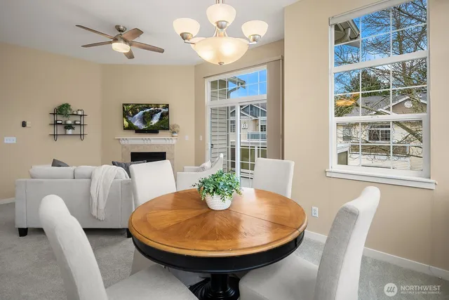 a dining room with furniture a potted plant and a chandelier