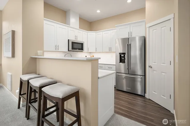 a kitchen with stainless steel appliances a refrigerator stove microwave and cabinets