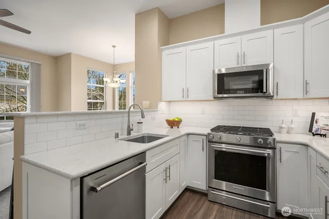 a kitchen with a sink stove and microwave