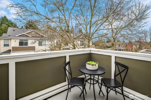 a view of a chairs and table in a balcony
