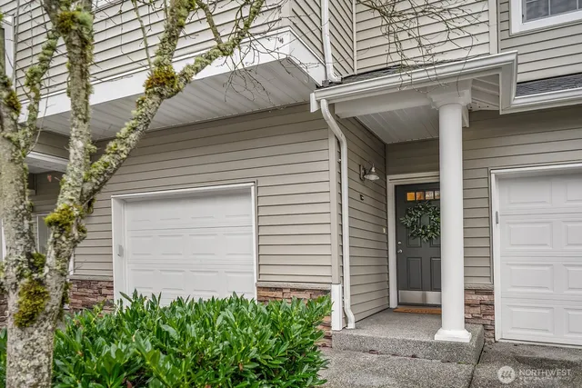 a small white building with a white door