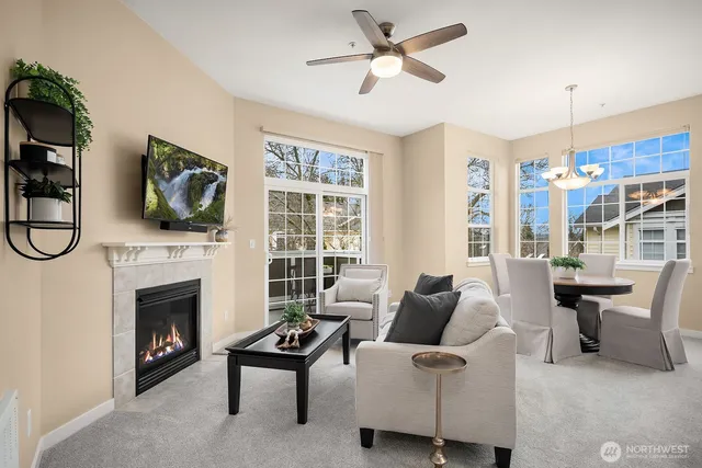 a living room with furniture a fireplace and a flat screen tv