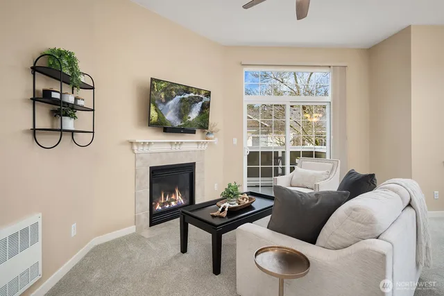 a living room with furniture a fireplace and a flat screen tv