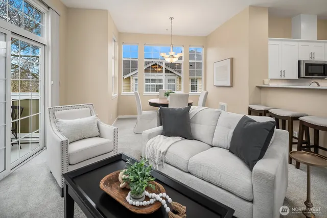 a living room with furniture and a chandelier