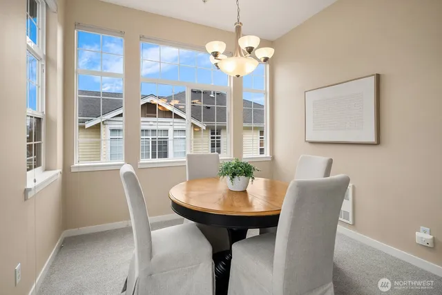 a view of a dining room with furniture and chandelier