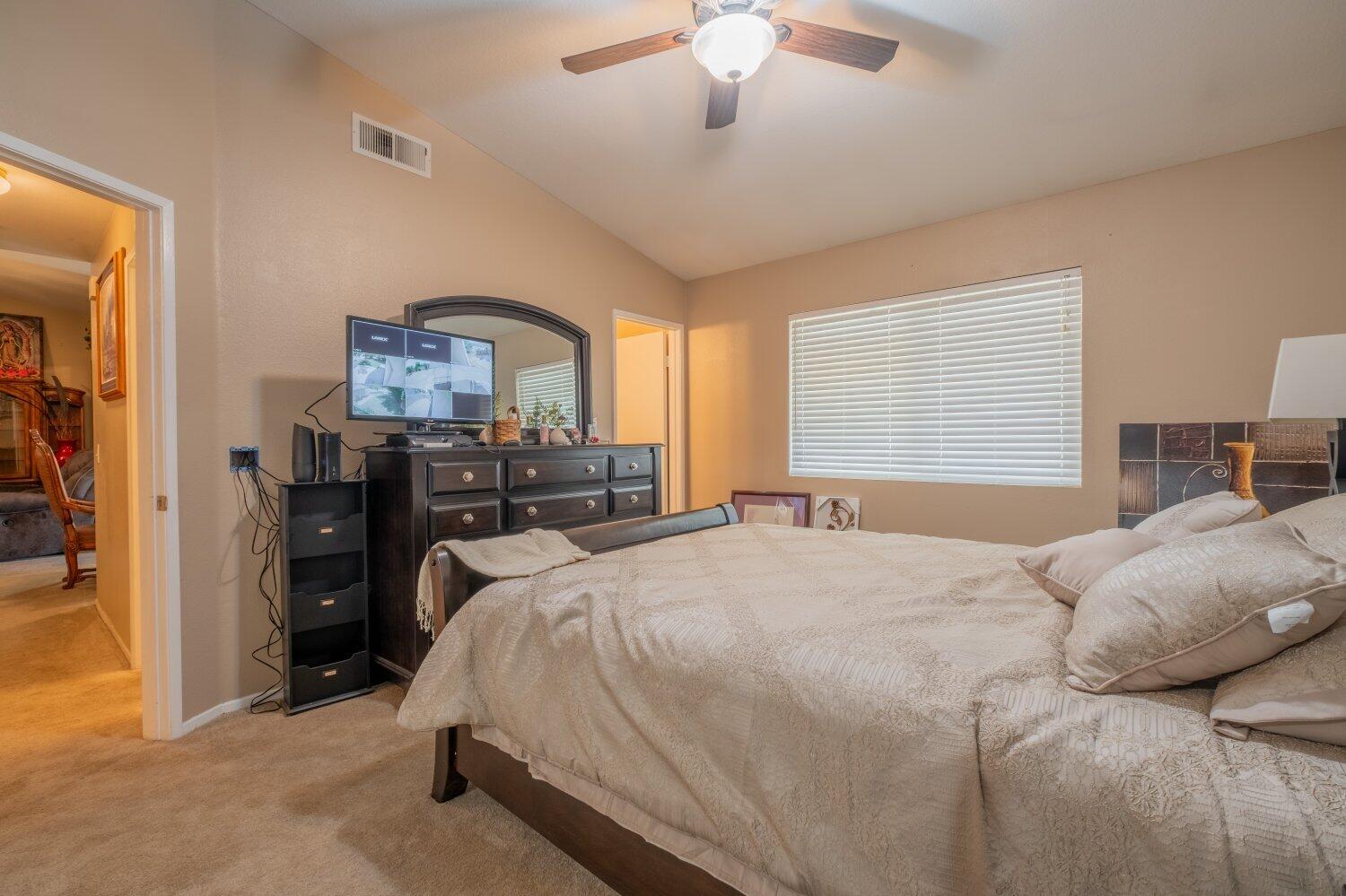 44628 Shadowcrest Drive Lancaster, CA 93536 - Photo 11 of 23 a bedroom with a bed and a chandelier