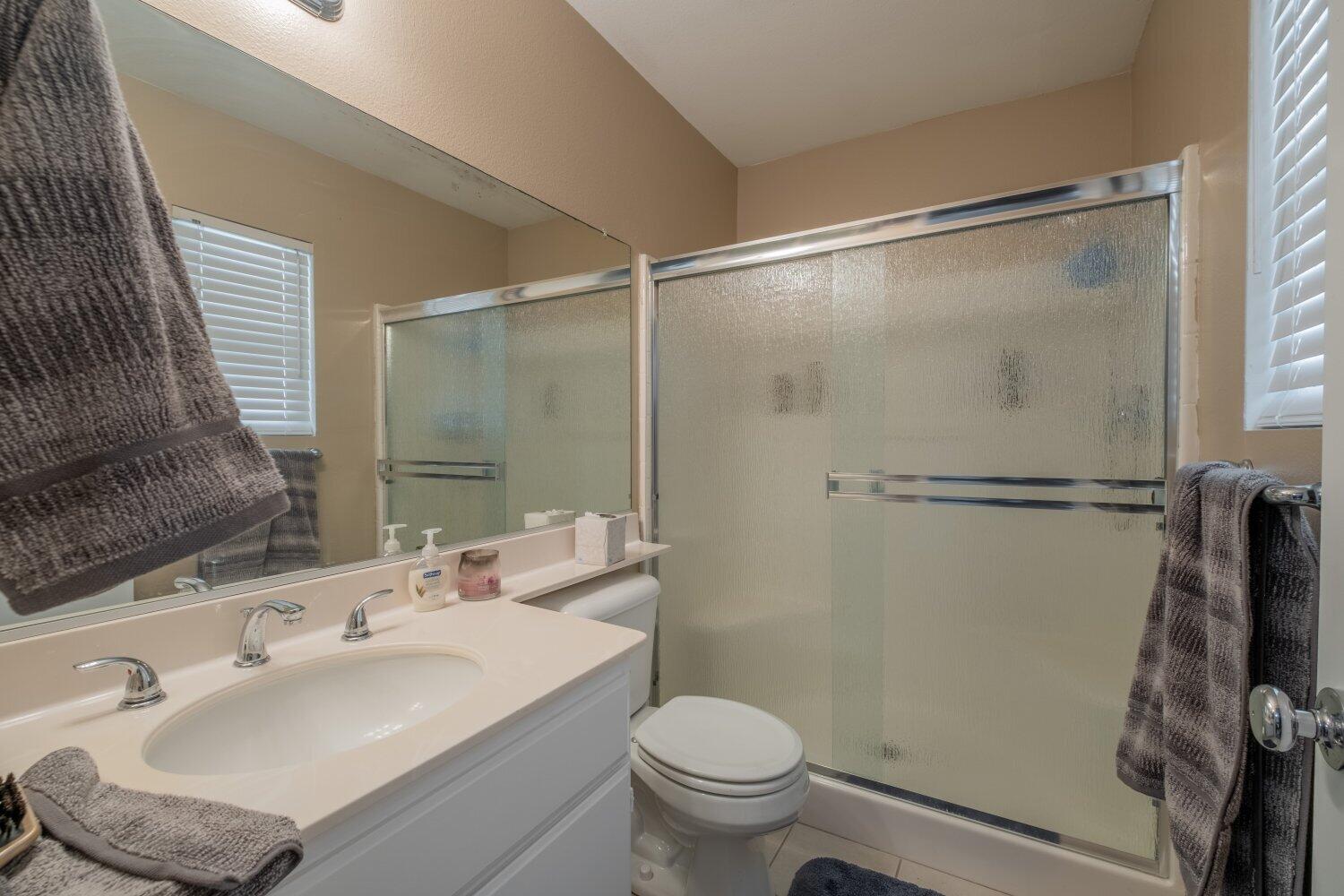 44628 Shadowcrest Drive Lancaster, CA 93536 - Photo 13 of 23 a bathroom with a sink toilet and shower