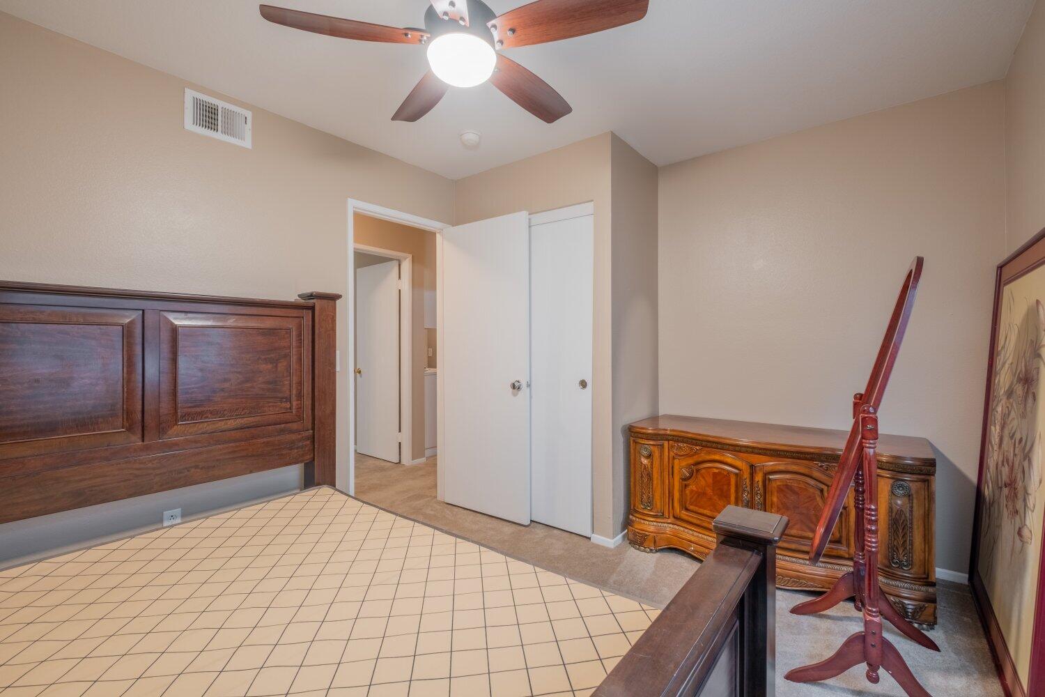 44628 Shadowcrest Drive Lancaster, CA 93536 - Photo 17 of 23 a bedroom with a bed and a chandelier