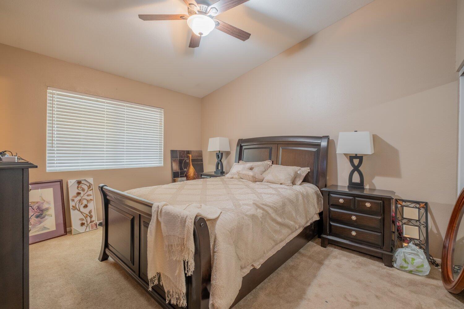44628 Shadowcrest Drive Lancaster, CA 93536 - Photo 10 of 23 a bedroom with a bed and a chandelier