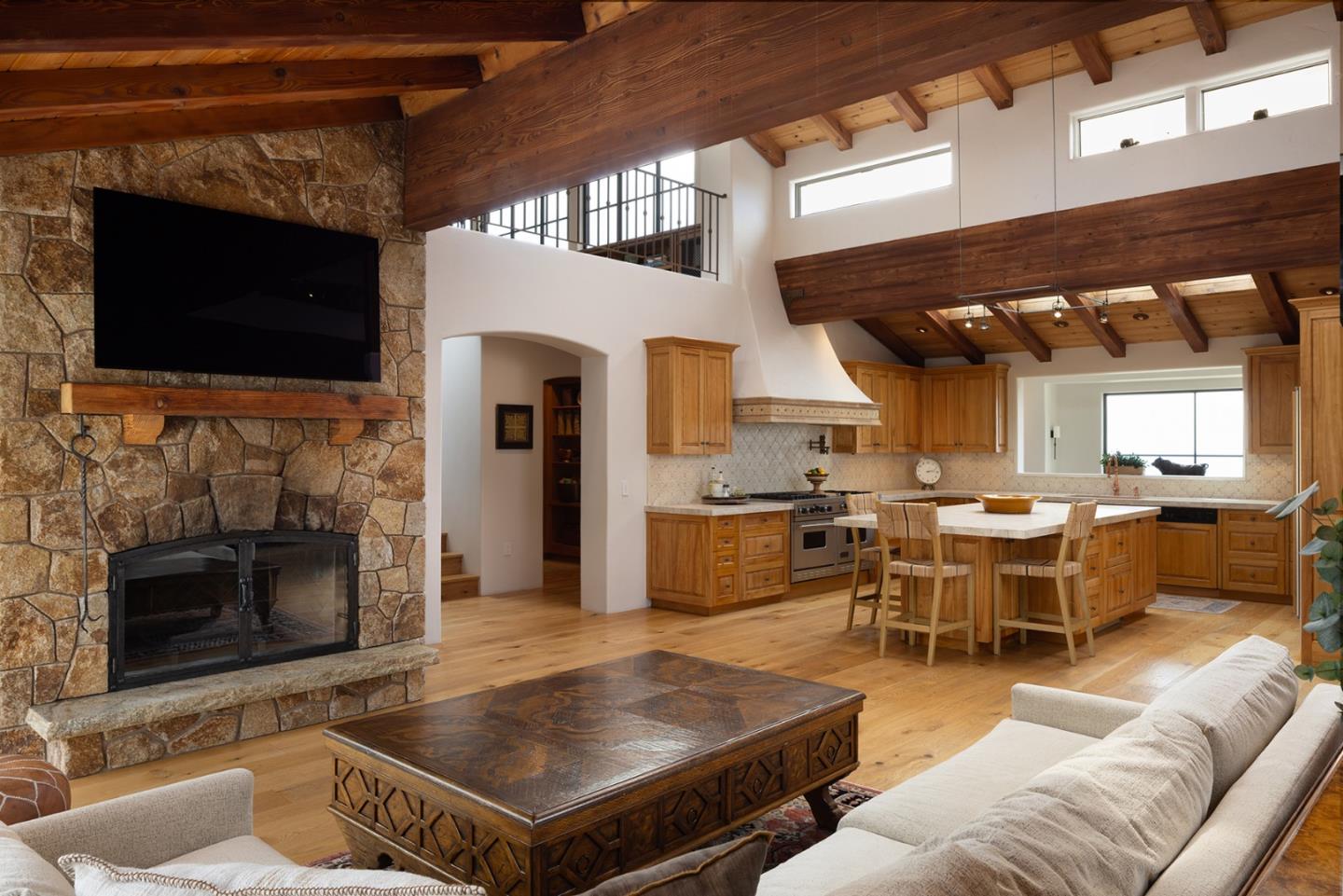 31453 Highway 1 Carmel, CA 93923 - Photo 26 of 58 a living room with furniture a flat screen tv and a fireplace