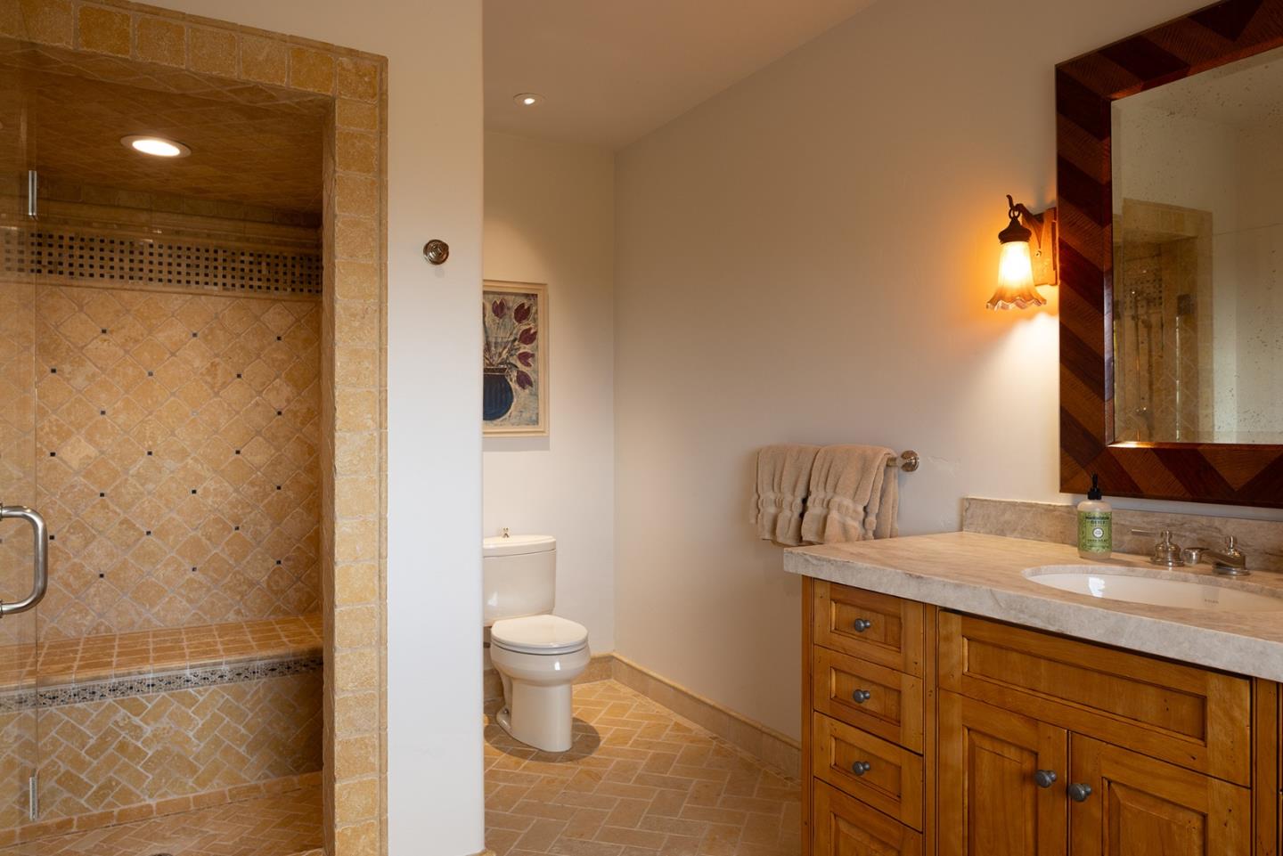 31453 Highway 1 Carmel, CA 93923 - Photo 53 of 58 a bathroom with a granite countertop sink toilet and shower