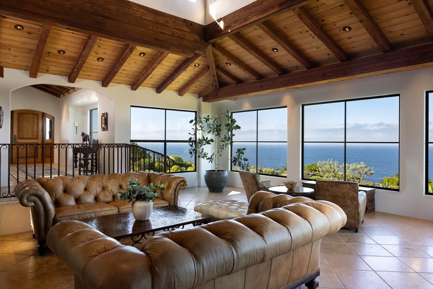 31453 Highway 1 Carmel, CA 93923 - Photo 8 of 58 a living room with furniture large windows and a chandelier