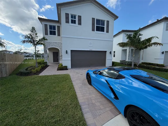 a backyard of a house with fireplace table and sofas