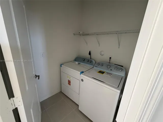 a bathroom with a double vanity sink toilet and shower