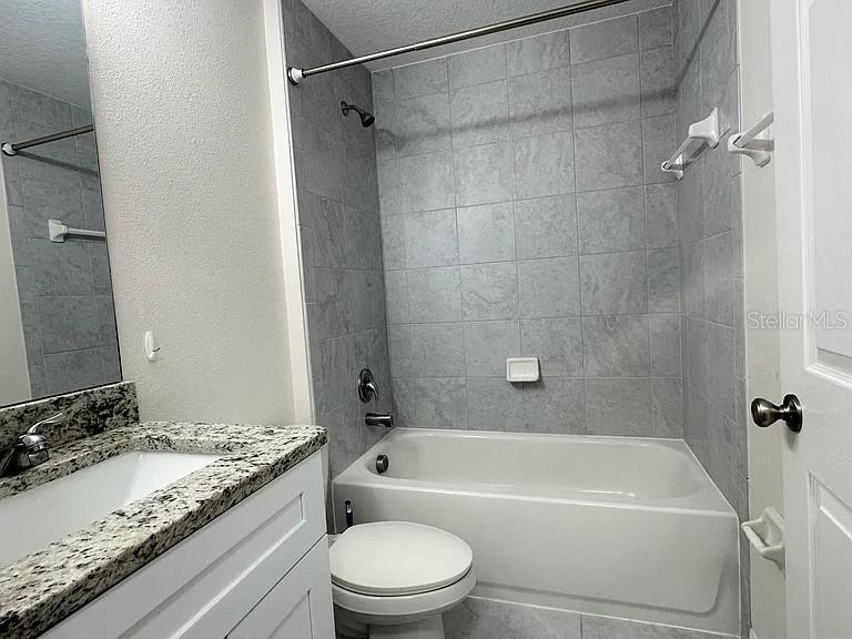 1737 North Lakewood Avenue Ocoee, FL 34761 - Photo 11 of 16 a bathroom with a granite countertop bathtub shower sink vanity and toilet
