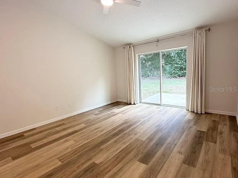 1737 North Lakewood Avenue Ocoee, FL 34761 - Photo 6 of 16 a view of an empty room with wooden floor and a window