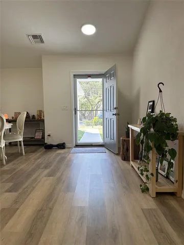 a view of a room with wooden floor air conditioner duct and windows
