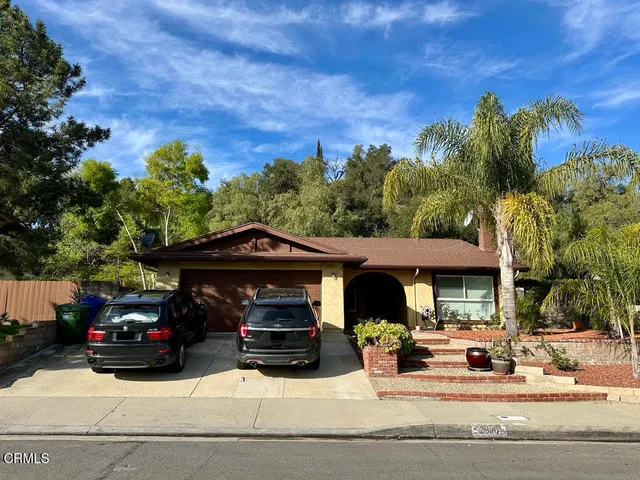 a view of a car parked in front of a house
