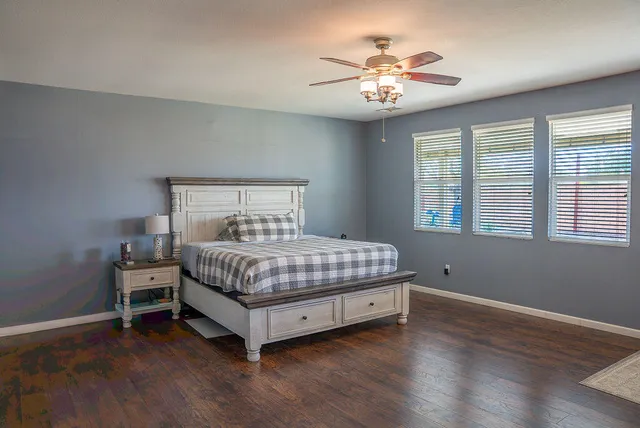 a bedroom with a bed and a chandelier
