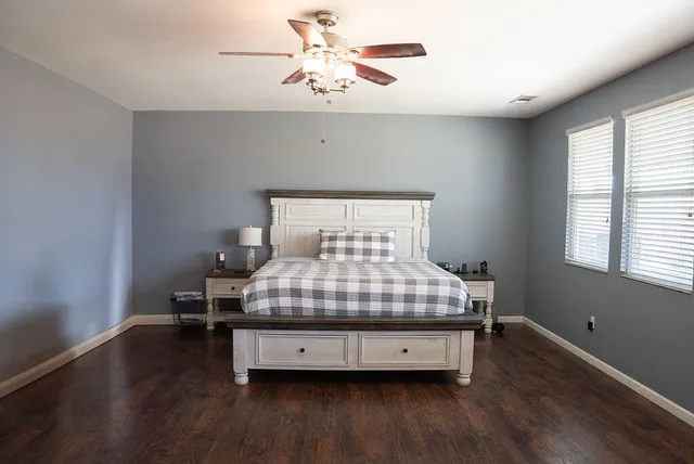 a bed sitting in a bedroom next to a window