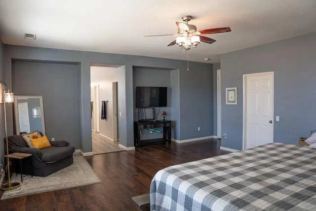 a bedroom with a bed and a chandelier