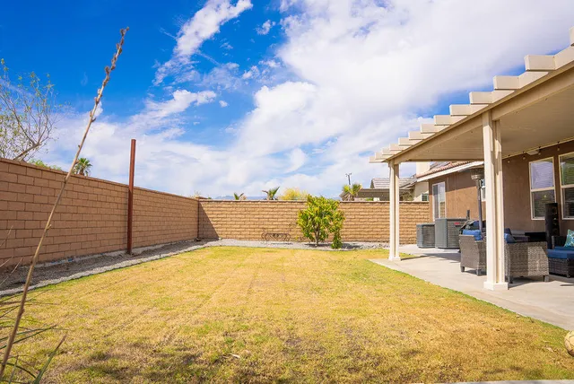 a view of backyard with swimming pool