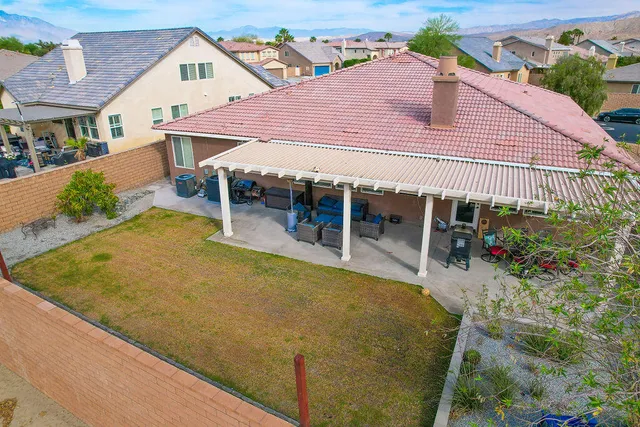 an aerial view of a house with swimming pool and porch