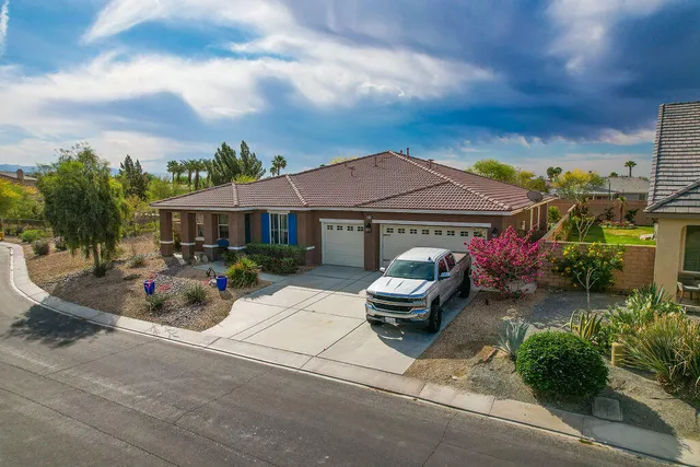 a view of a patio with table and chairs under an umbrella